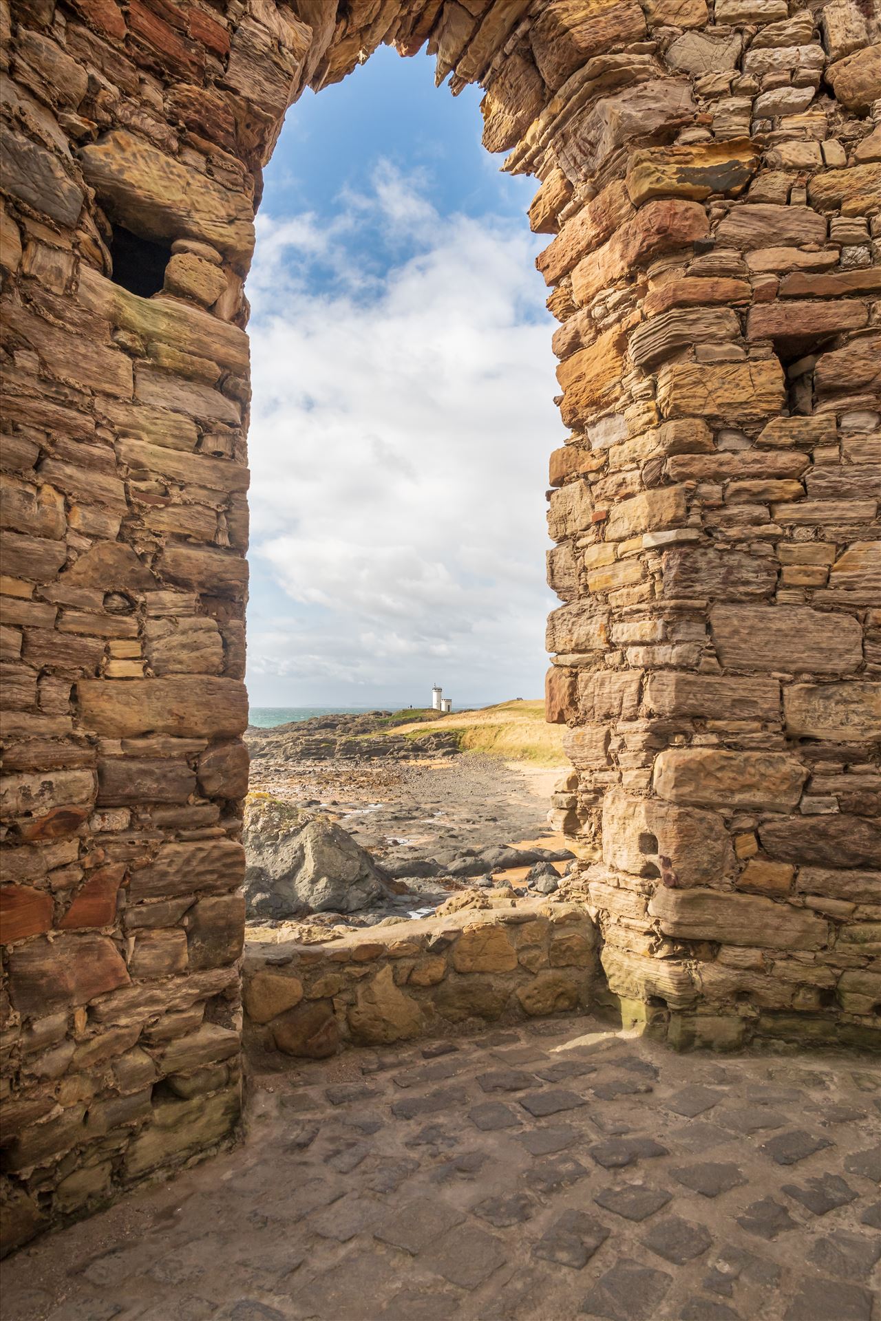Lady Elie Tower, Elie, Scotland - Lady Elie Tower, looking towards Elie lighthouse through arched window.  A changing tower for Lady Anstruther when bathing in the 1770s. by Graham Dobson Photography